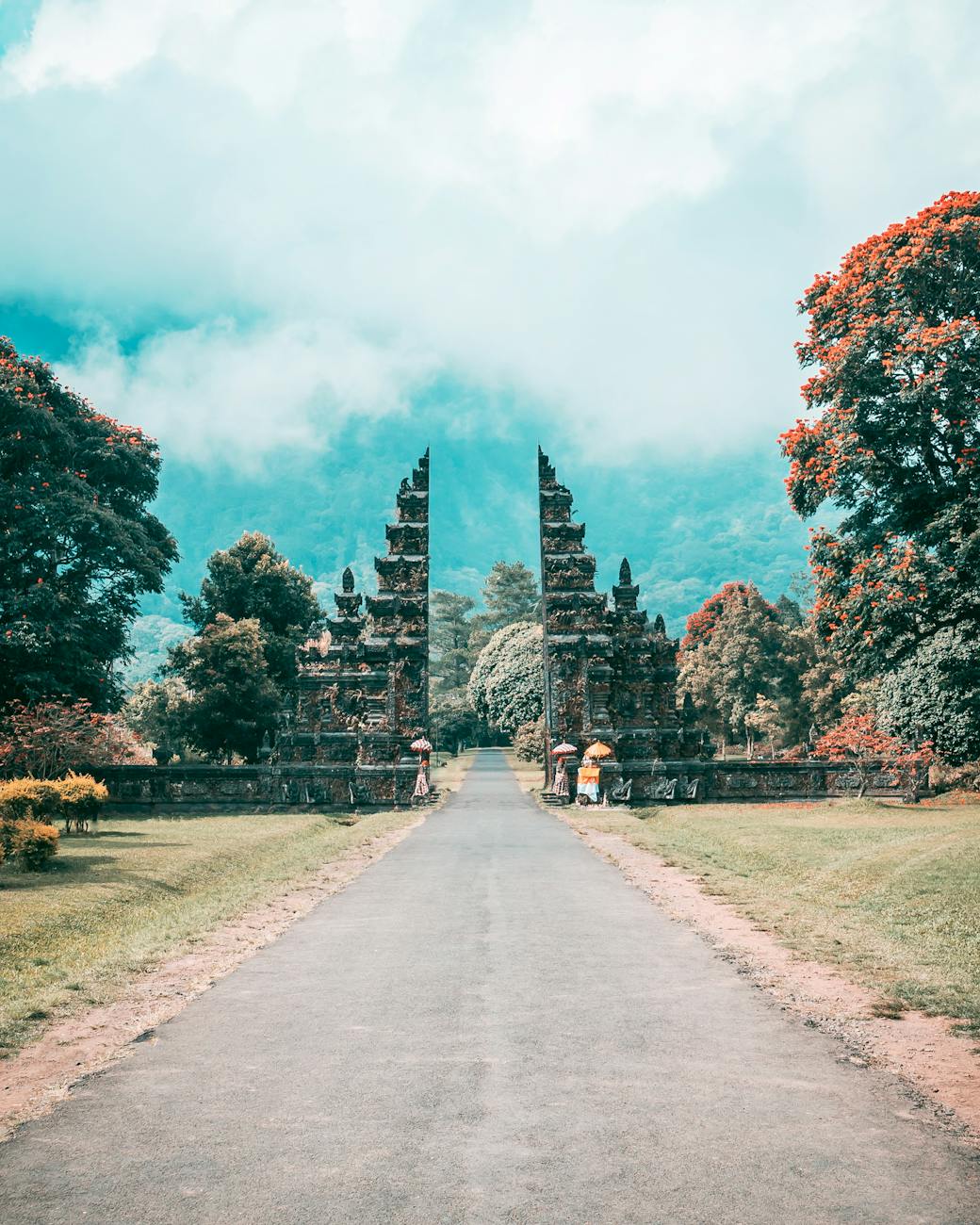 Where is Bali? A Complete Travel Guide to the Island Paradise for Americans 8 asphalt road near black concrete arch gate beside trees bali